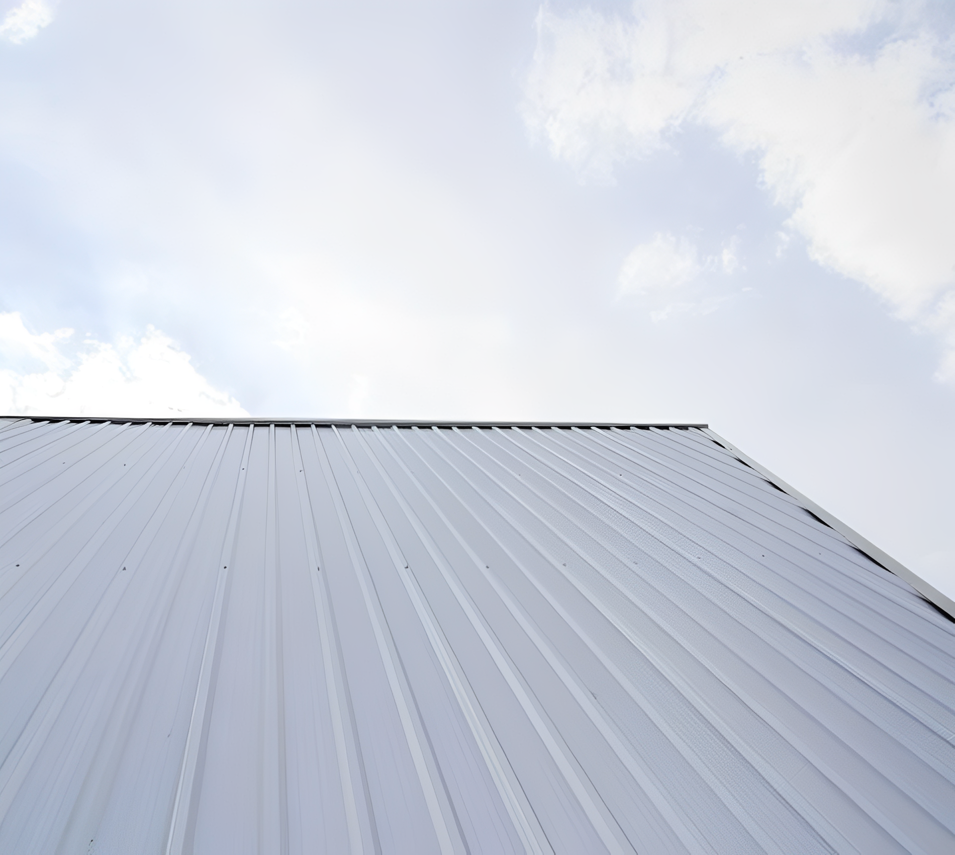 Metal roof against a cloudy sky.